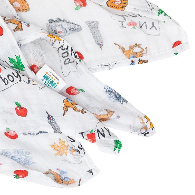 New York-themed baby boy muslin swaddle blanket with iconic landmarks and symbols in soft pastel colors.