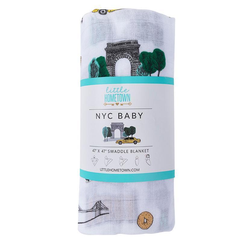 White muslin swaddle blanket featuring a colorful, whimsical map of New York City with landmarks and icons.