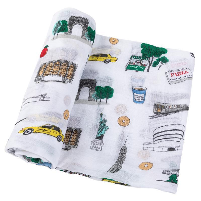 New York City-themed baby muslin swaddle blanket featuring iconic landmarks in soft pastel colors.