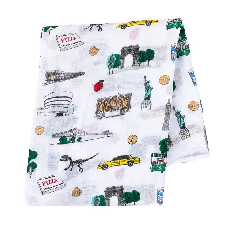 White muslin swaddle blanket with colorful New York City icons like taxis, skyscrapers, and the Statue of Liberty.