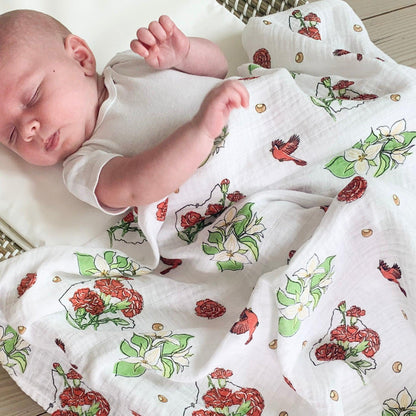 Ohio-themed baby muslin swaddle blanket with delicate floral patterns in soft pastel colors, laid flat.