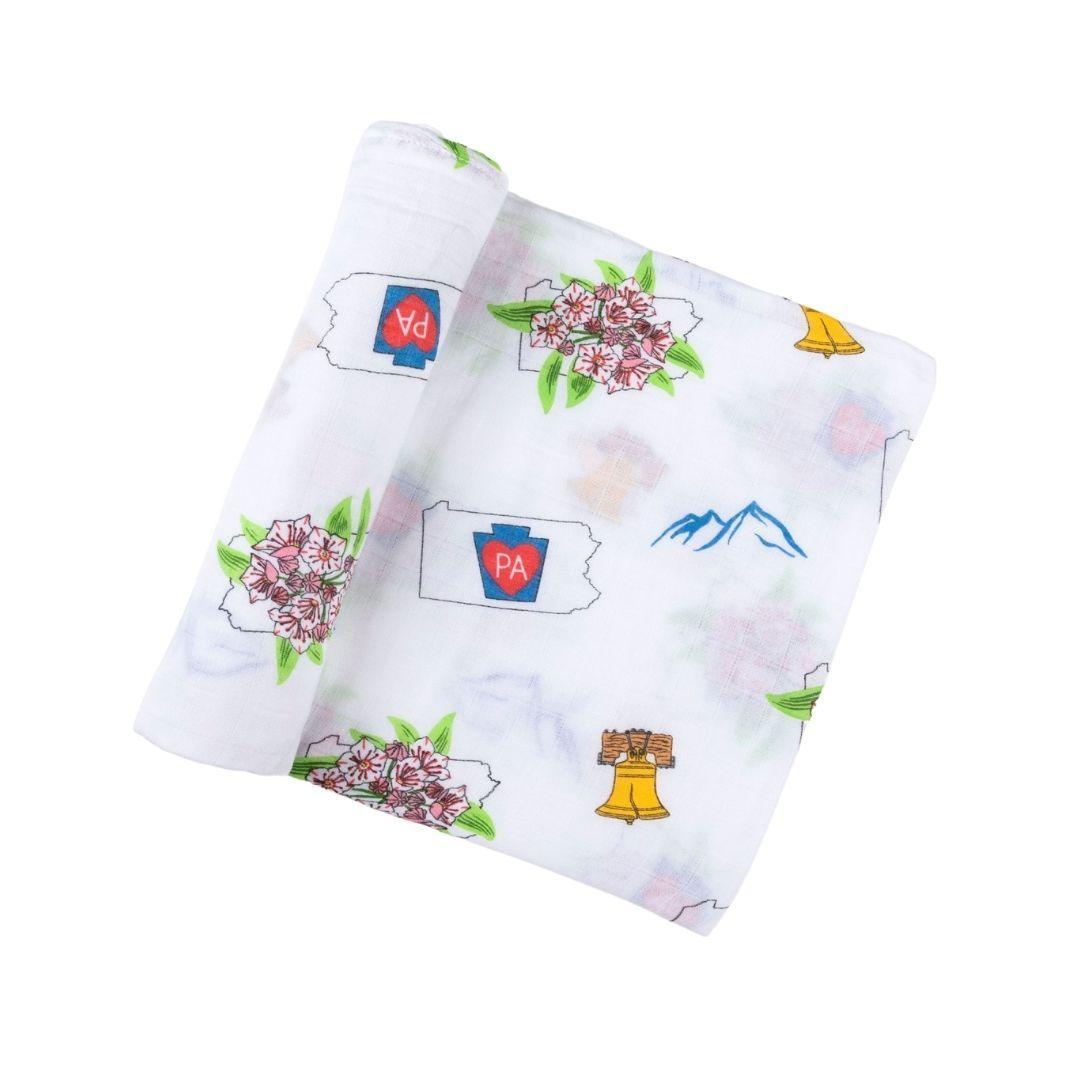 Pennsylvania-themed baby muslin swaddle blanket with state icons like Liberty Bell, deer, and covered bridge.