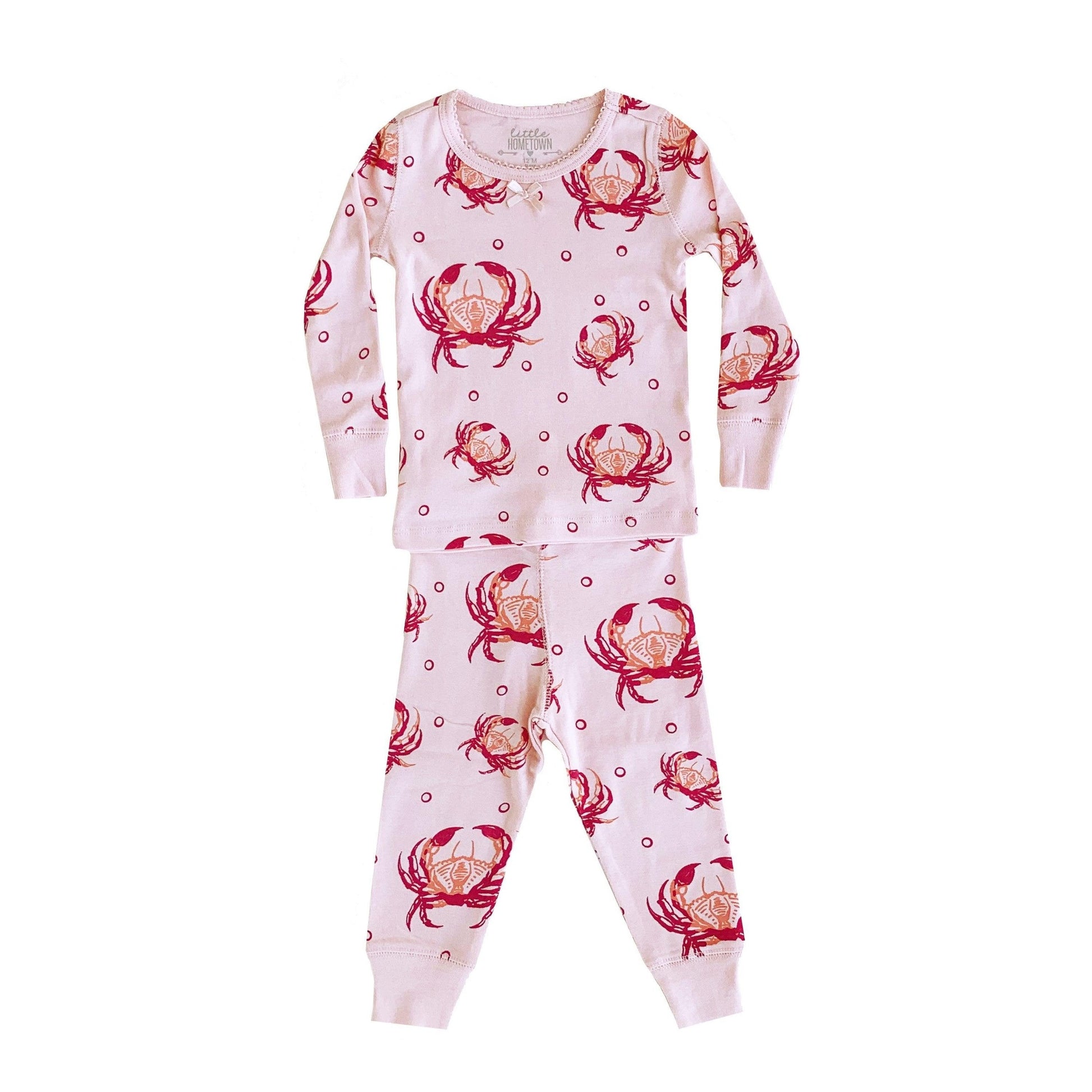 Pink children's pajamas with playful crab illustrations, featuring a cozy long-sleeve top and matching pants.