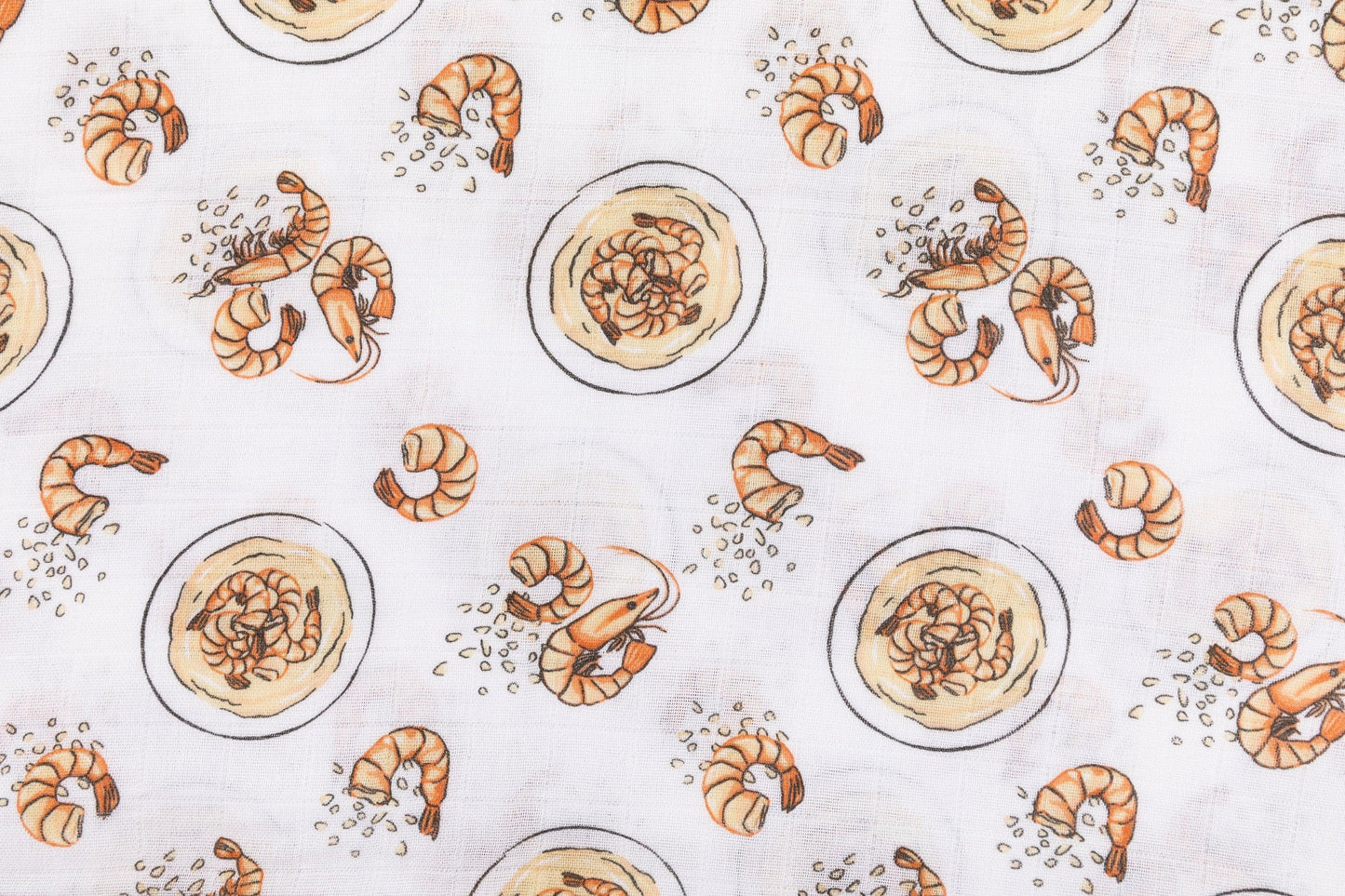 White muslin swaddle blanket with colorful shrimp and grits pattern, featuring bowls, shrimp, and corn.