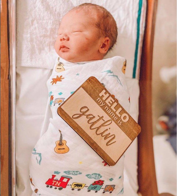 Tennessee-themed baby muslin swaddle blanket featuring state icons like guitars, horses, and musical notes.