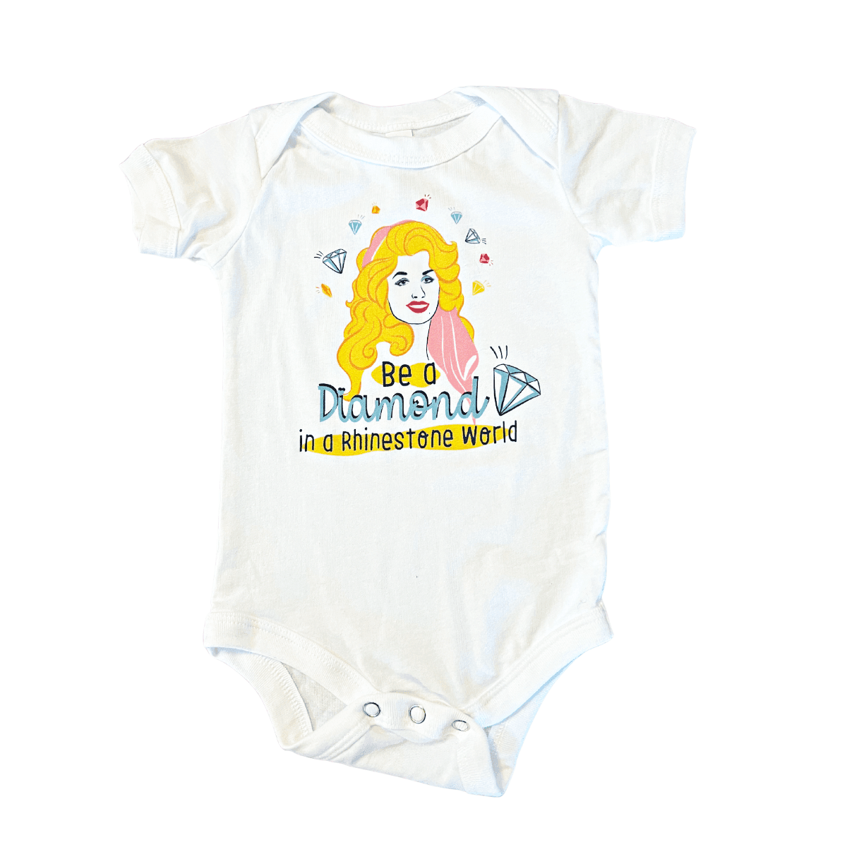 White baby onesie with "Tennessee Dolly" text and a cartoon of Dolly Parton in a pink dress and cowboy boots.