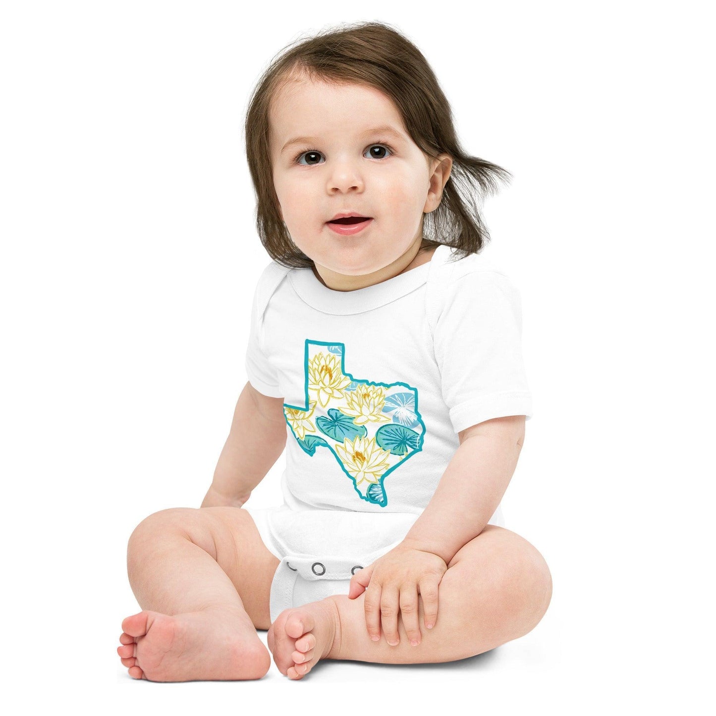 White baby onesie with a map of Texas and a colorful yellow and green Texas Dawn floral image