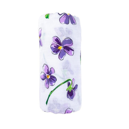 Soft violet muslin swaddle blanket with white floral patterns, neatly folded on a white background.