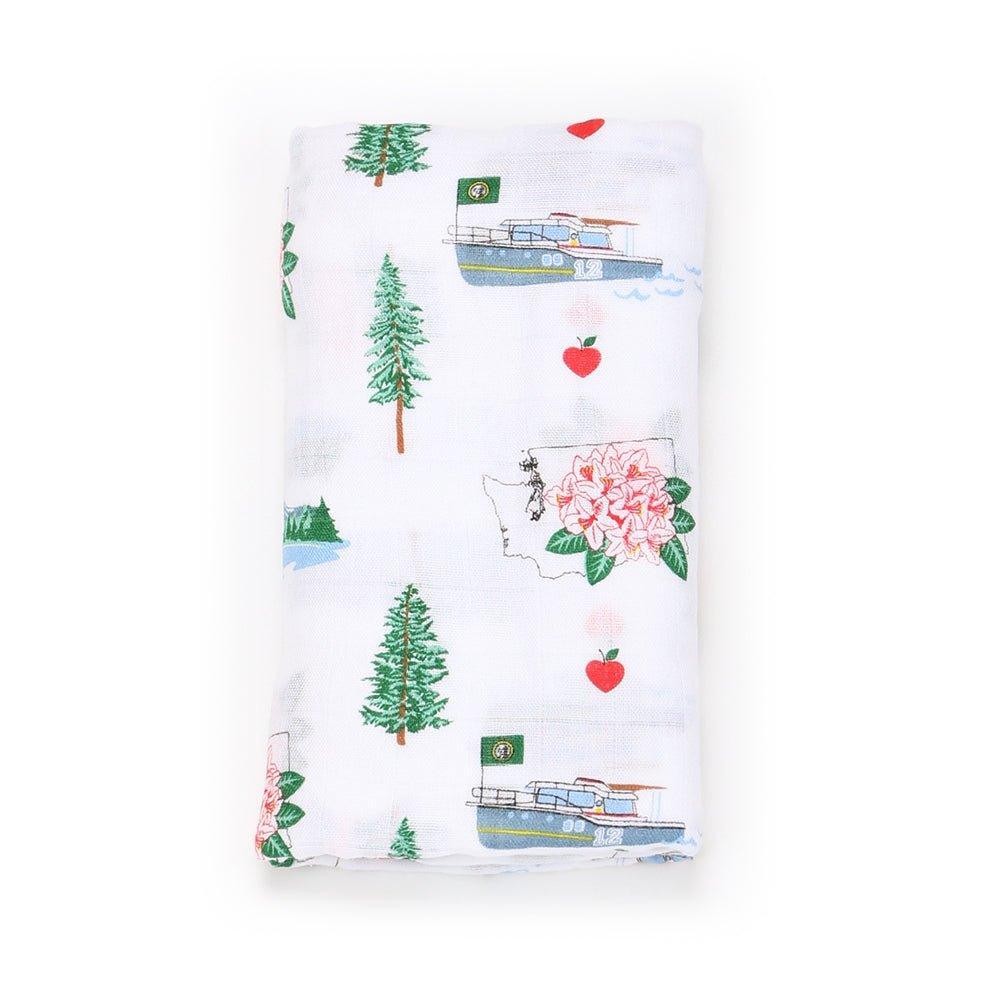 White muslin swaddle blanket with colorful illustrations of Washington State landmarks, animals, and icons.